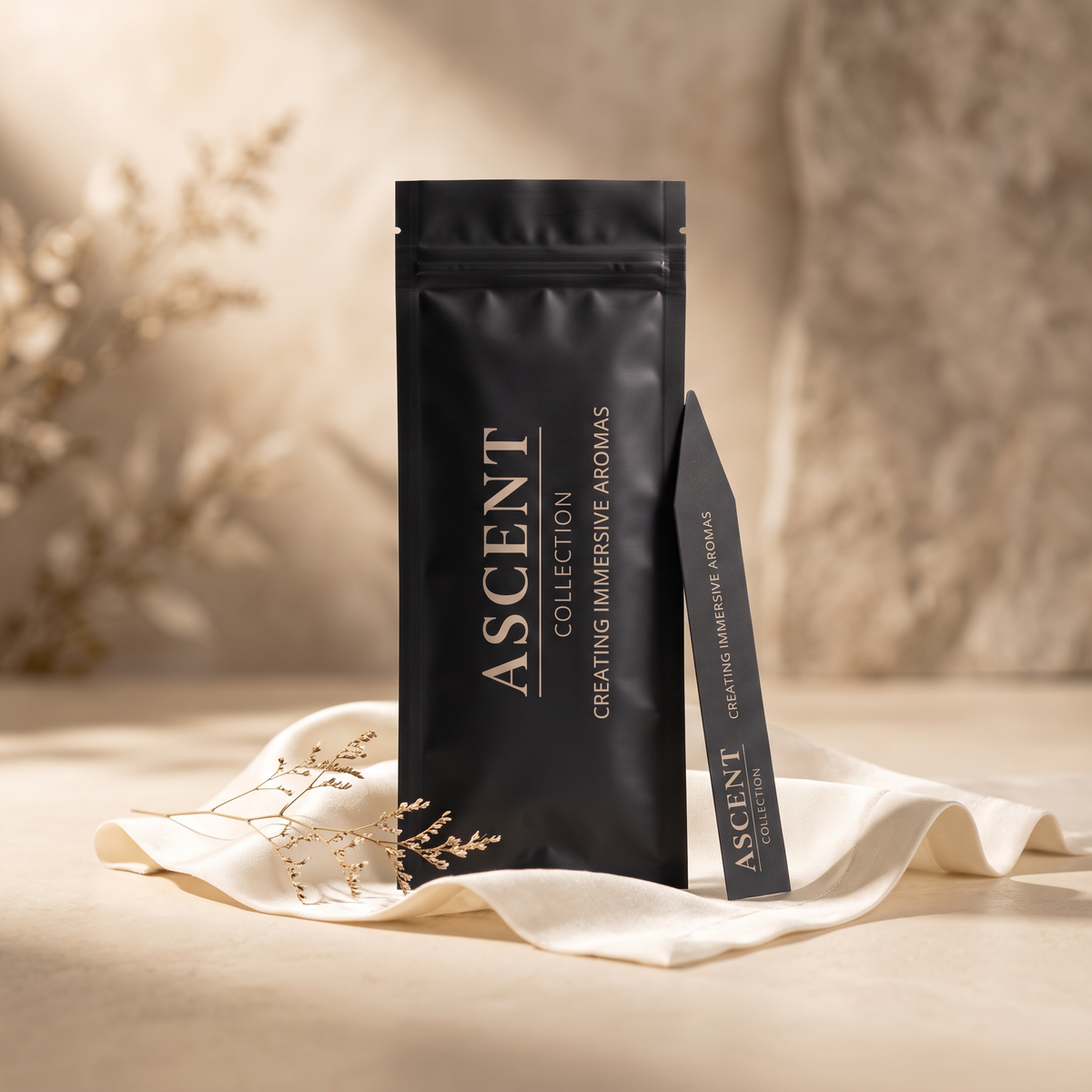 Ascent Collection Fragrance Test Strip Sample Pack — matte black pouch and test strip on ivory silk